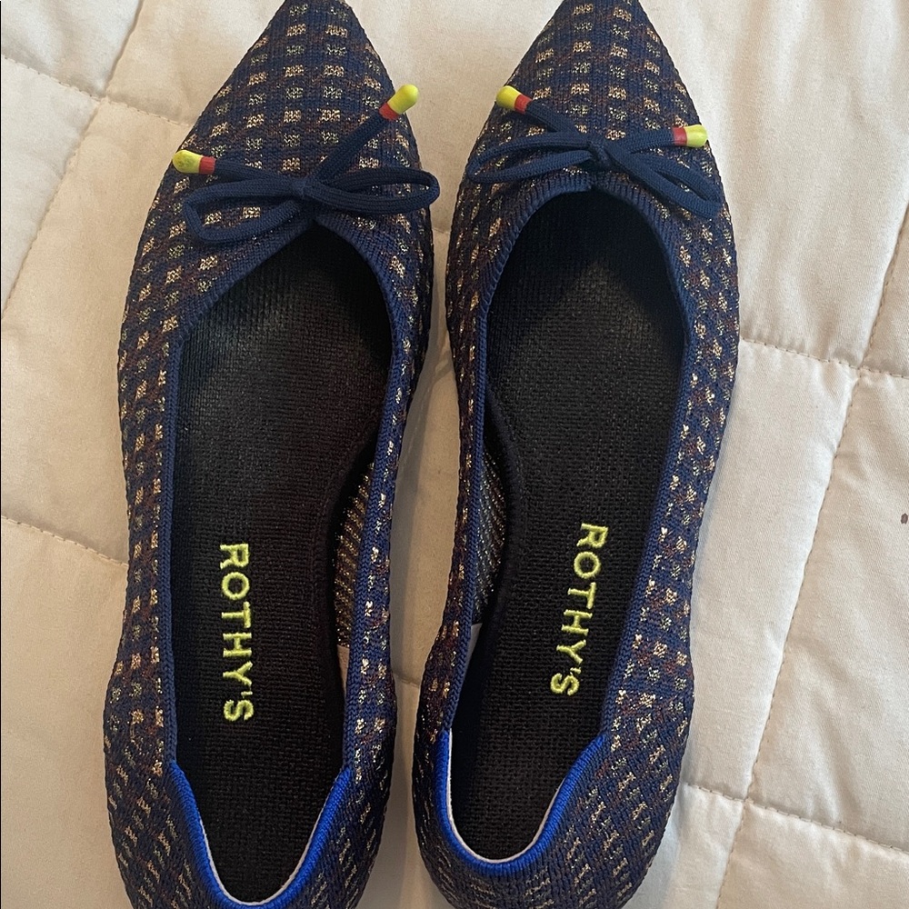 Rothy’s rare navy blue with gold threads.